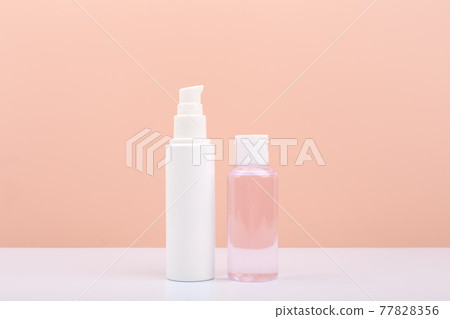 Cosmetic tubes with face cream and lotion for skin cleaning and exfoliating against bright pink background Cosmetic tubes with face cream and lotion for skin cleaning and exfoliating against bright pink background 77828356