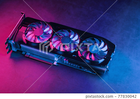 Large and powerful graphics card with three fans with blue pink light. Large and powerful graphics card with three fans with blue pink light. 77830042