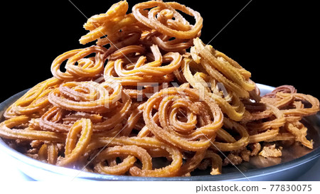 Indian Traditional Tea Time Snack Chakli, a deep fried snack, It is known as Chakali, Murukku, Muruku, Murkoo, Chakri. Indian Traditional Tea Time Snack Chakli, a deep fried snack, It is known as Chakali, Murukku, Muruku, Murkoo, Chakri. 77830075