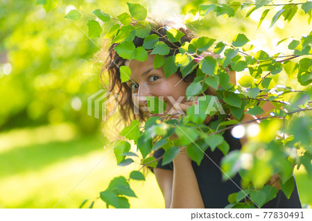 Portrait of young beautiful brunette enjoy walking in green summer park 77830491