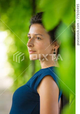 Portrait of young beautiful brunette enjoy walking in green summer park Portrait of young beautiful brunette enjoy walking in green summer park 77830495