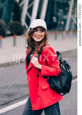 glamour woman in trendy outfit posing against the building urban background, fashion look. Outdoor fashion portrait of stylish young woman 77831007