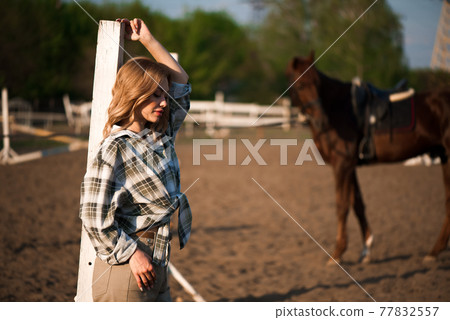Young cheerful girl with her favorite horse. Young cheerful girl with her favorite horse. 77832557