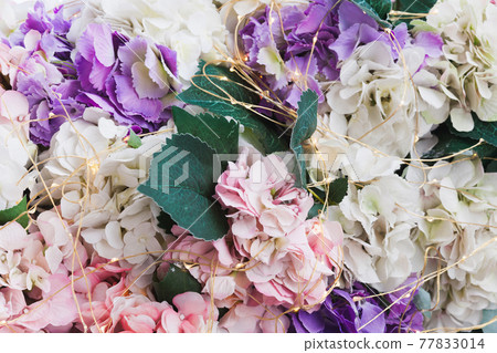 Artificial decorative flowers and an electric garland 77833014