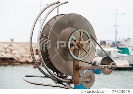 Fishing net winch a on small boat. Close-up 77833049
