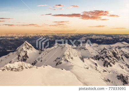Aerial View from Airplane of Blue Snow Covered Canadian Mountain Landscape Aerial View from Airplane of Blue Snow Covered Canadian Mountain Landscape 77833091
