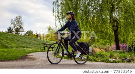 Adventure Woman Bike Riding in a Park Adventure Woman Bike Riding in a Park 77833149