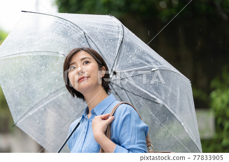 Young woman rain umbrella rainy season 77833905