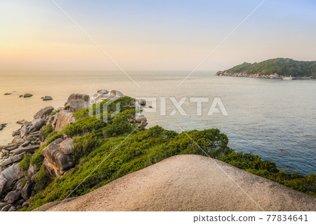 View of the bay of one of the Similan Islands in Thailand at sunset from the top of the mountain 77834641