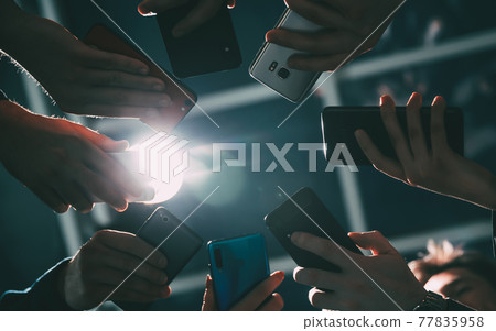 diverse smartphones are in the hands of young business people . diverse smartphones are in the hands of young business people . 77835958