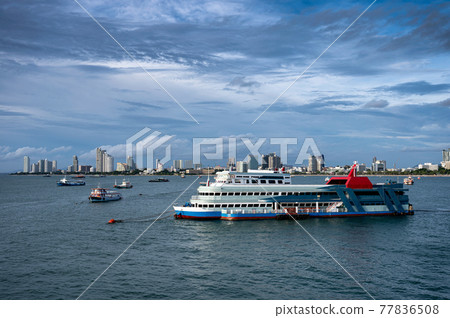 Ferry boat floating on tropical sea and buildings downtown on coastline Ferry boat floating on tropical sea and buildings downtown on coastline 77836508