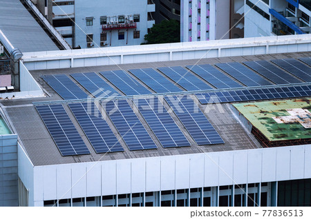 Row of solar panel renewable and sustainable energy on roof of building in downtown 77836513