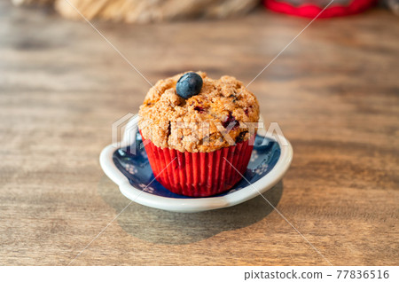 Homemade baked blueberry muffin on wooden table 77836516