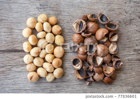 Organic Macadamia nuts and shell on wood table 77836601