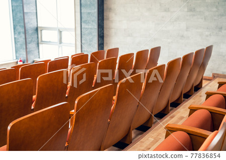 Rear of row brown theatre seats in auditorium 77836854