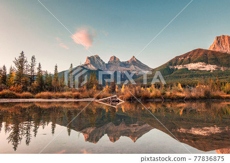 Three sisters mountains of rocky mountains reflection on bow river in the morning at Canmore, Banff national park 77836875