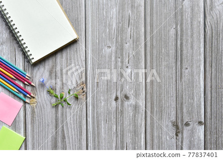Still life, business office supplies or education concept, Top view image of open notebook and colorful pencil with tiny flower on blank pages on old brown wooden, ready for adding text Still life, business office supplies or education concept, Top view image of open notebook and colorful pencil with tiny flower on blank pages on old brown wooden, ready for adding text 77837401