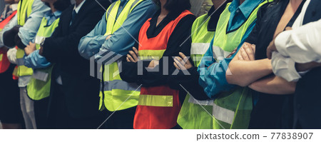 Large group of factory worker standing together in warehouse or storehouse Large group of factory worker standing together in warehouse or storehouse 77838907