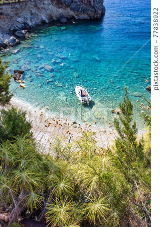 Small hidden beach with turquoise water 77838922