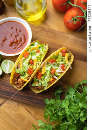 hard shell taco on wooden board with lime hard shell taco on wooden board with lime 77839442