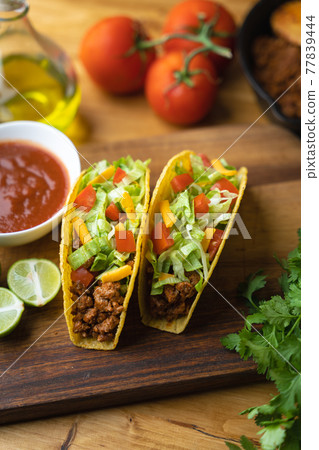 hard shell taco on wooden board with lime hard shell taco on wooden board with lime 77839444