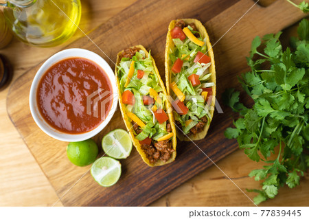 hard shell taco on wooden board with lime hard shell taco on wooden board with lime 77839445