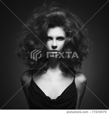 Beautiful woman with volume wavy hair 77839479