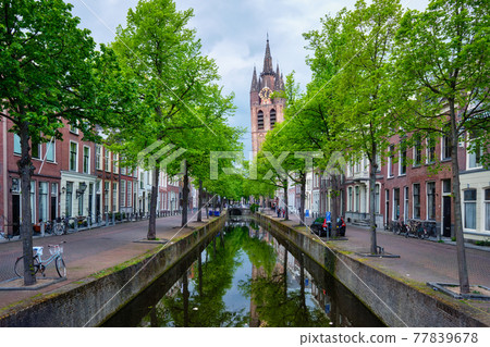 Delt canal with bicycles and cars parked along. Delft, Netherlands 77839678