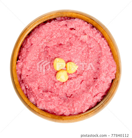 Beetroot hummus dip with chickpea garnish in a wooden bowl. Middle Eastern dip, spread or savory dish made of cooked, mashed chickpeas, blended with boiled beets, tahini, lemon juice and garlic. Photo Beetroot hummus dip with chickpea garnish in a wooden bowl. Middle Eastern dip, spread or savory dish made of cooked, mashed chickpeas, blended with boiled beets, tahini, lemon juice and garlic. Photo 77840112
