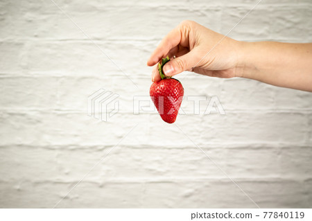 Ripe juicy red beautiful strawberry close-up is an appetizing fresh snack Ripe juicy red beautiful strawberry close-up is an appetizing fresh snack 77840119