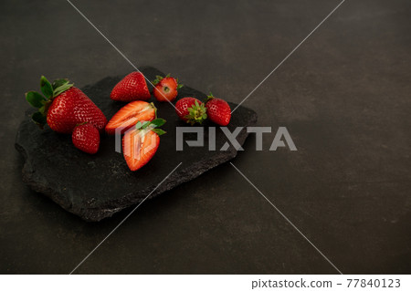 Ripe juicy red beautiful strawberry close-up is an appetizing fresh snack Ripe juicy red beautiful strawberry close-up is an appetizing fresh snack 77840123