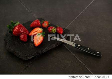 Ripe juicy red beautiful strawberry close-up is an appetizing fresh snack Ripe juicy red beautiful strawberry close-up is an appetizing fresh snack 77840124
