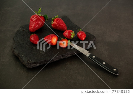 Ripe juicy red beautiful strawberry close-up is an appetizing fresh snack Ripe juicy red beautiful strawberry close-up is an appetizing fresh snack 77840125