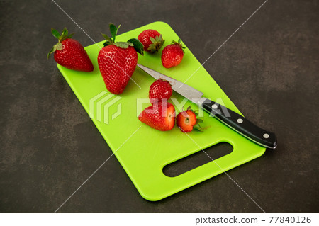 Ripe juicy red beautiful strawberry close-up is an appetizing fresh snack Ripe juicy red beautiful strawberry close-up is an appetizing fresh snack 77840126