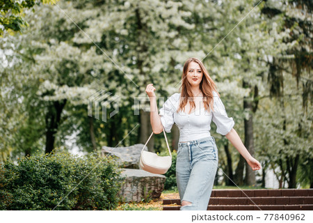 Spring Nature. Tender woman portrait in blooming emerald garden. smiling happy cute girl with lifestyle activity outdoor. Spring Nature. Tender woman portrait in blooming emerald garden. smiling happy cute girl with lifestyle activity outdoor. 77840962