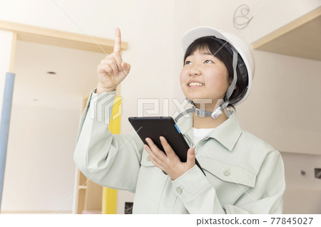 Remodeling a child worker who holds a tablet and checks the interior 77845027