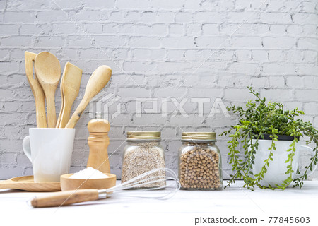 Kitchen tools and kitchenware utensil object with ingredients and mix nut on kitchen shelf Kitchen tools and kitchenware utensil object with ingredients and mix nut on kitchen shelf 77845603