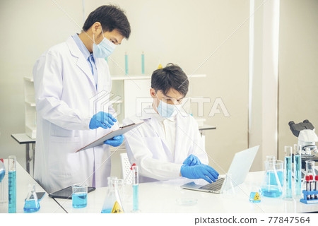 Two asian scientist team reserch chemistry science tube experiment biotech antibody sample in laboratory Cultivate Vaccine against covid-19 virus. Scientist consult, analyze in Chemistry Laboratory Two asian scientist team reserch chemistry science tube experiment biotech antibody sample in laboratory Cultivate Vaccine against covid-19 virus. Scientist consult, analyze in Chemistry Laboratory 77847564