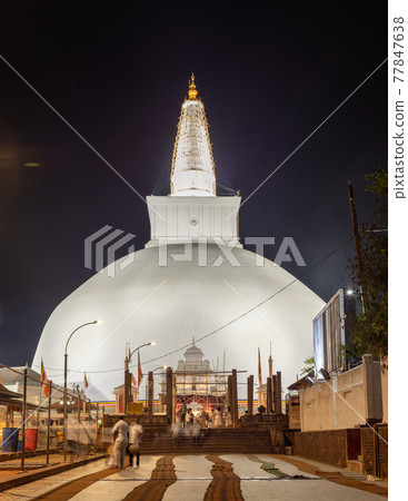 Ruwanwelisaya stupa glowing in the night, it is a hemispherical structure and containing sacred Buddha's relics built by King Dutugamunu. 77847638