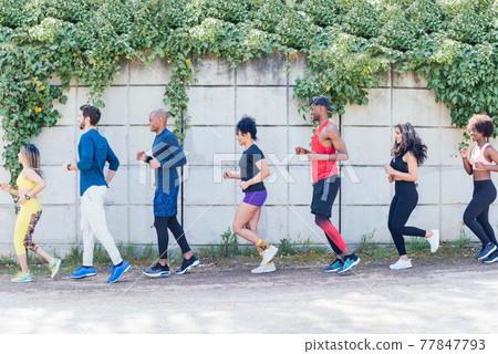 Group of runners training in a park. Group of runners training in a park. 77847793