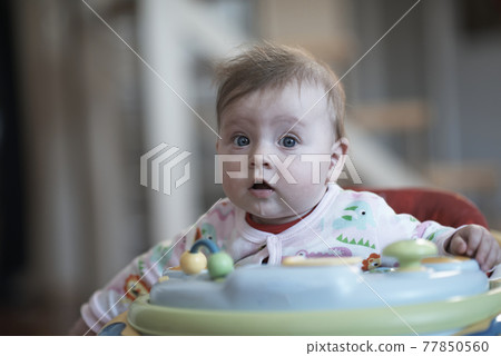 baby learning to walk in walker baby learning to walk in walker 77850560