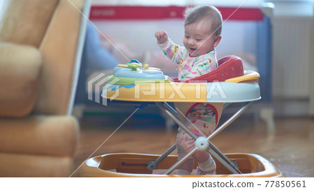 baby learning to walk in walker baby learning to walk in walker 77850561