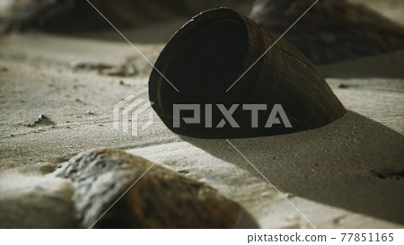 Old wooden barrel on the beach 77851165