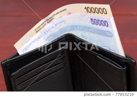 Uzbekistani money - som in the wallet 77853210