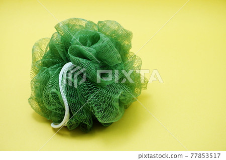 Green bath soft with rope on Yellow background 77853517