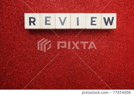 Review alphabet letter with space copy on red glitter background Review alphabet letter with space copy on red glitter background 77854006
