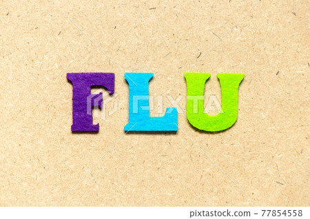 Color cloth alphabet letter in word flu on wood background 77854558