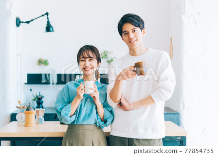 Young couple couple with coffee cup 77854735