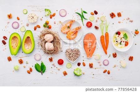 Ketogenic low carbs diet concept. Ingredients for healthy foods selection set up on white wooden background. Ketogenic low carbs diet concept. Ingredients for healthy foods selection set up on white wooden background. 77856428