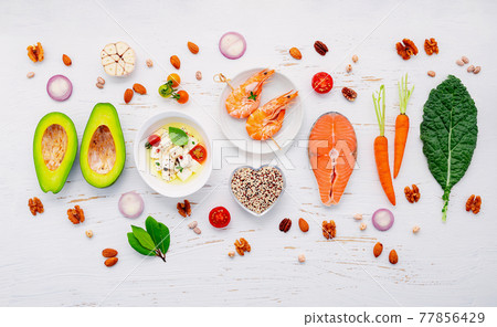 Ketogenic low carbs diet concept. Ingredients for healthy foods selection set up on white wooden background. Ketogenic low carbs diet concept. Ingredients for healthy foods selection set up on white wooden background. 77856429